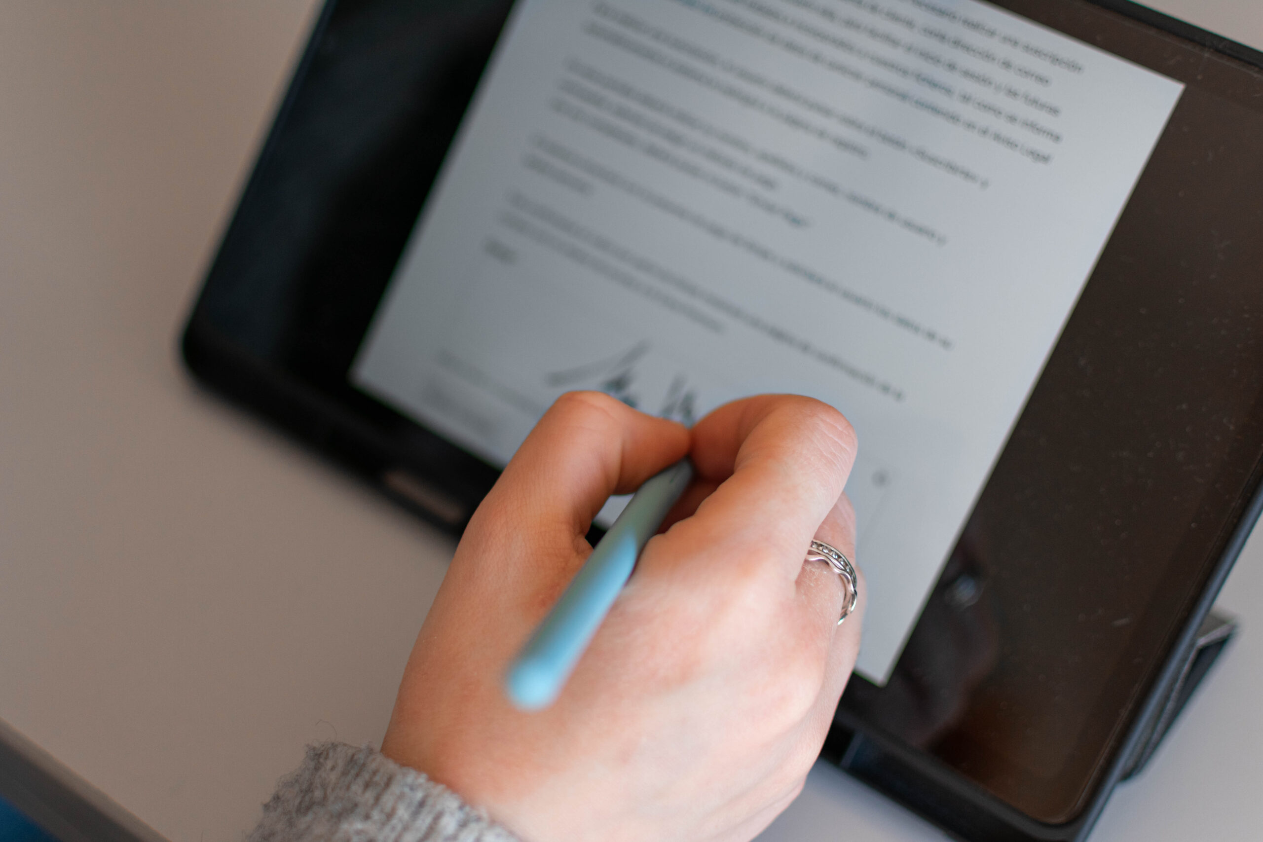 Digital document signing on a tablet using electronic signature software for secure and paperless contract approval.