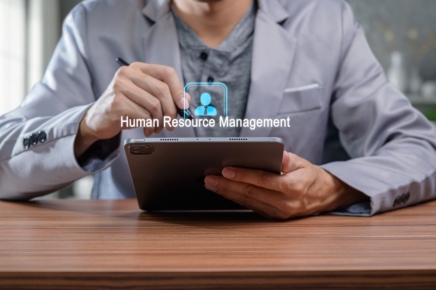 HR professional managing digital documents on a tablet using HR onboarding eSignatures and electronic signature technology