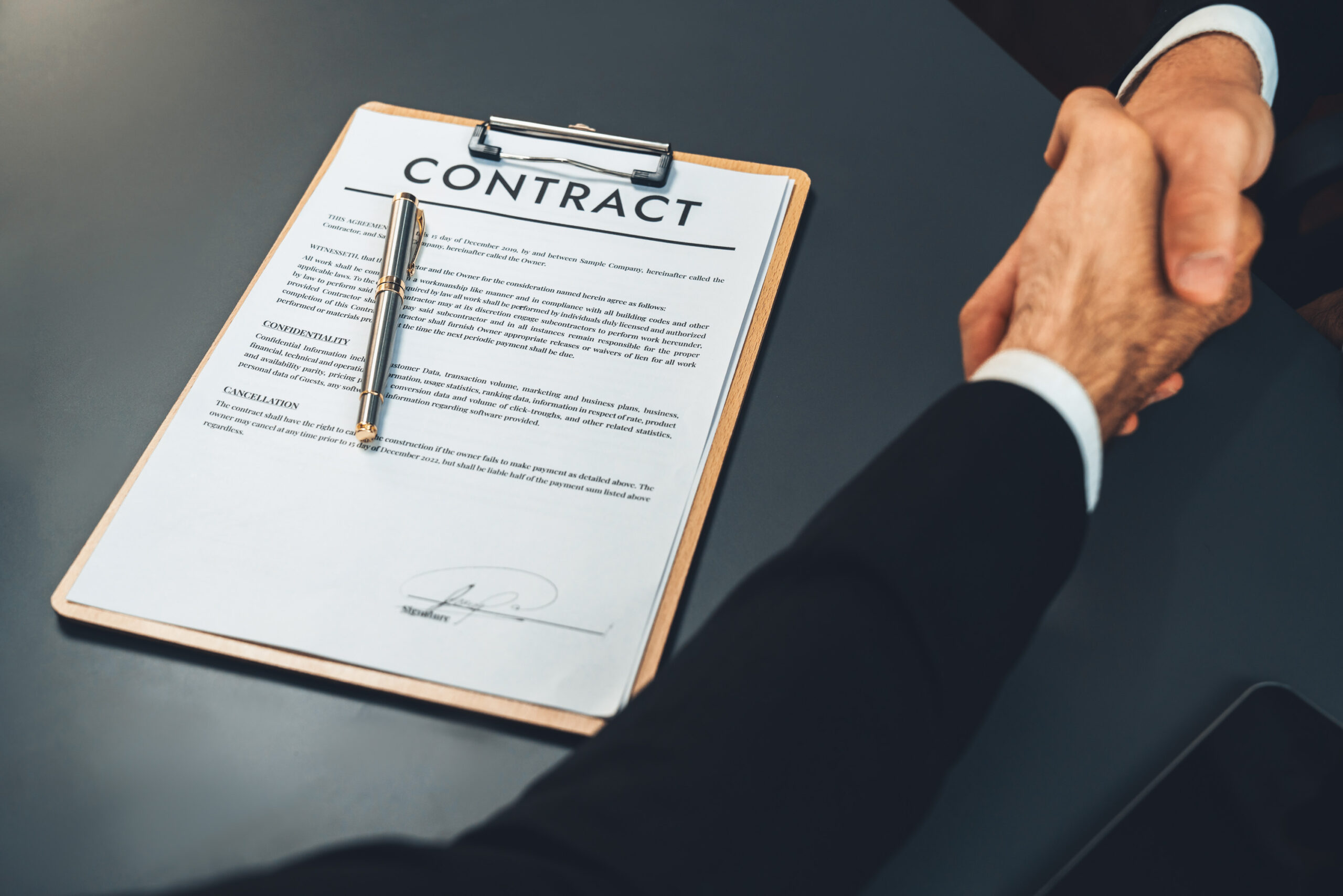 Business partners shaking hands after completing a deal using a free electronic contract signing platform supported by a reliable contract signing tool.
