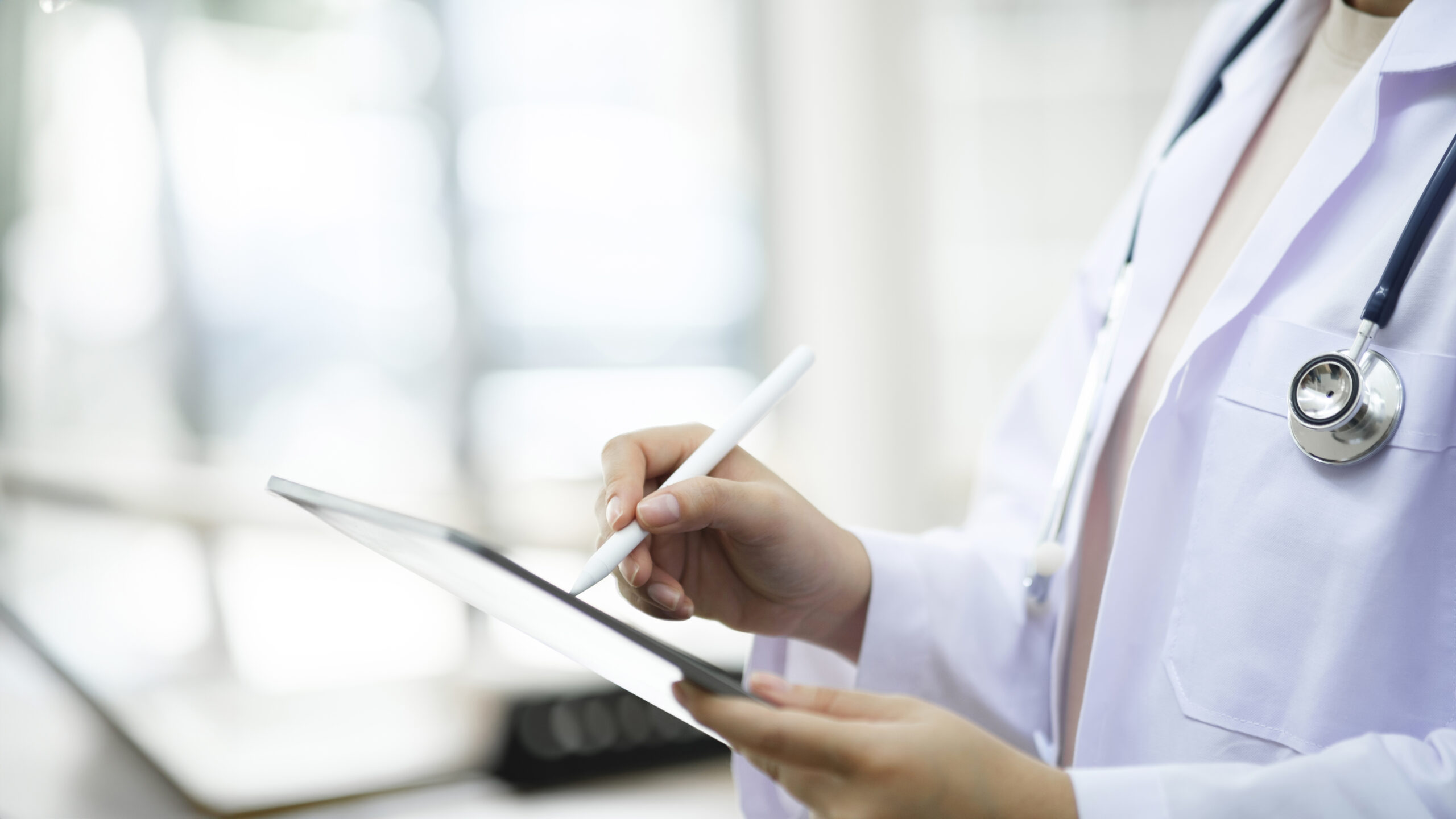 Healthcare professional using a tablet to review digital forms with Electronic Signature for Healthcare, supported by esignature online free options and the best esignature software.