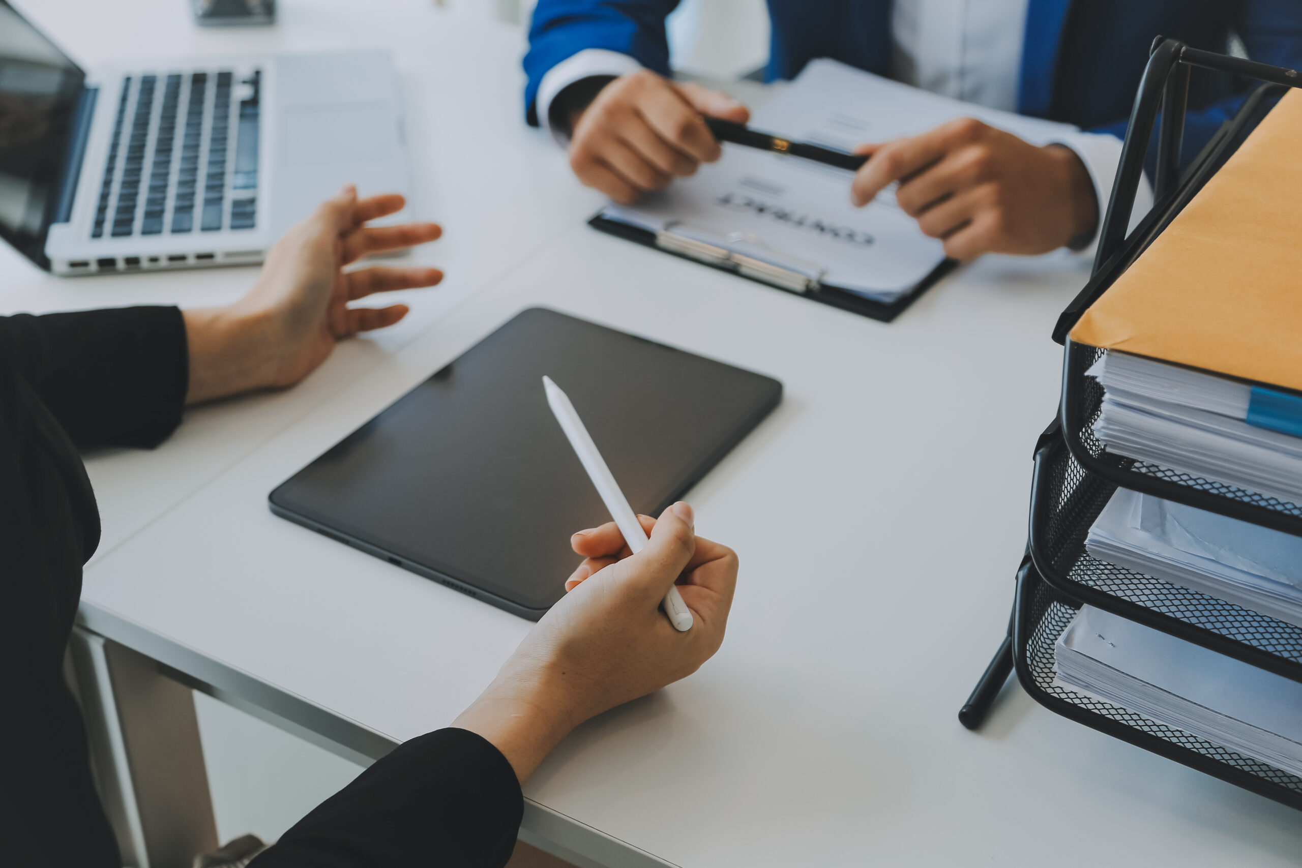 Team reviewing documents during secure electronic contract signing, using an electronic signature for contracts to streamline approvals and reduce paperwork.