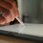 A person using a stylus to sign a digital document on a tablet, symbolizing secure and reliable electronic signature software for safe online document signing.