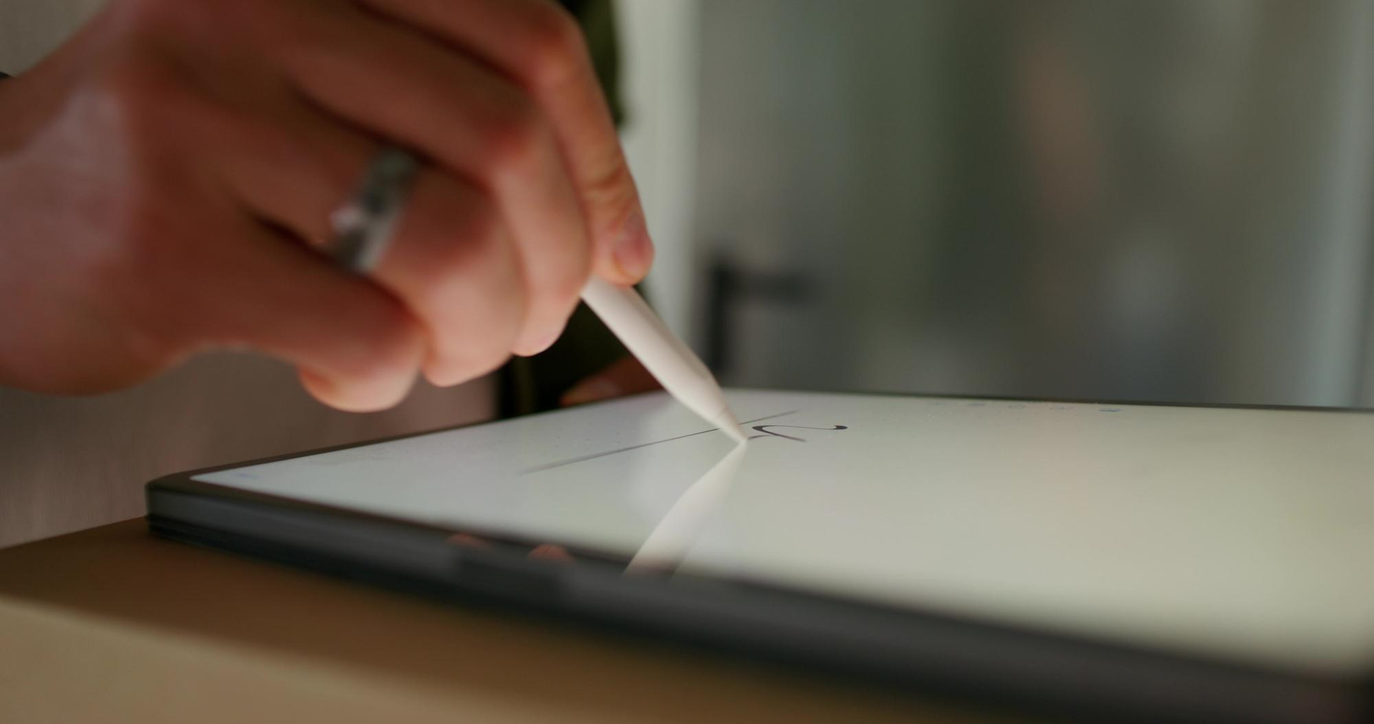 A person using a stylus to sign a digital document on a tablet, symbolizing secure and reliable electronic signature software for safe online document signing.