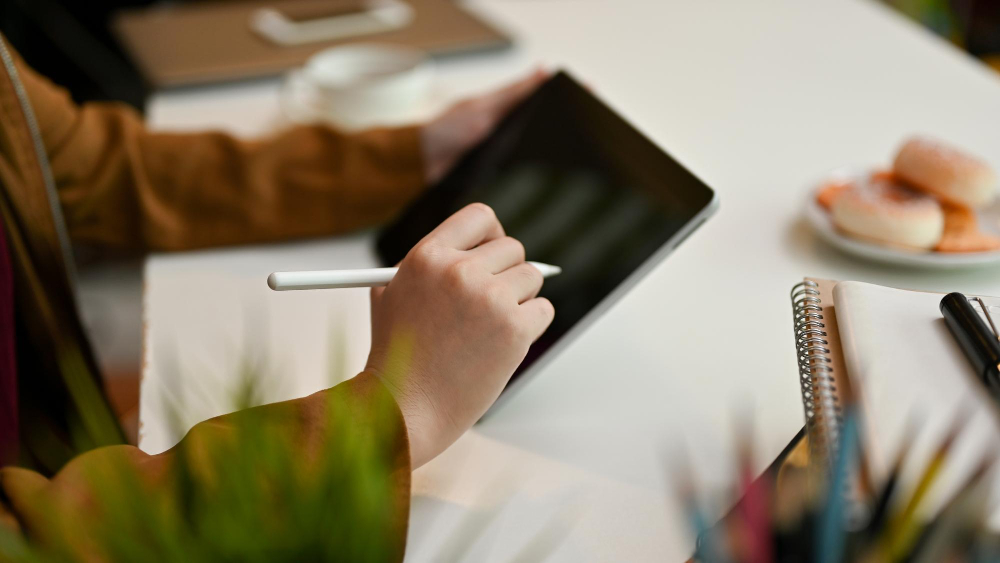 Person signing a digital document on a tablet using a stylus, showcasing how electronic signature software is transforming modern business operations across industries.