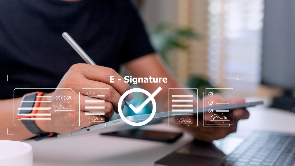 Person using a tablet to sign digital documents with an e-signature, representing modern online signing and secure electronic signature technology in 2025.