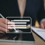 Business professional signing digital documents on a tablet using electronic signature technology for faster financial account opening.