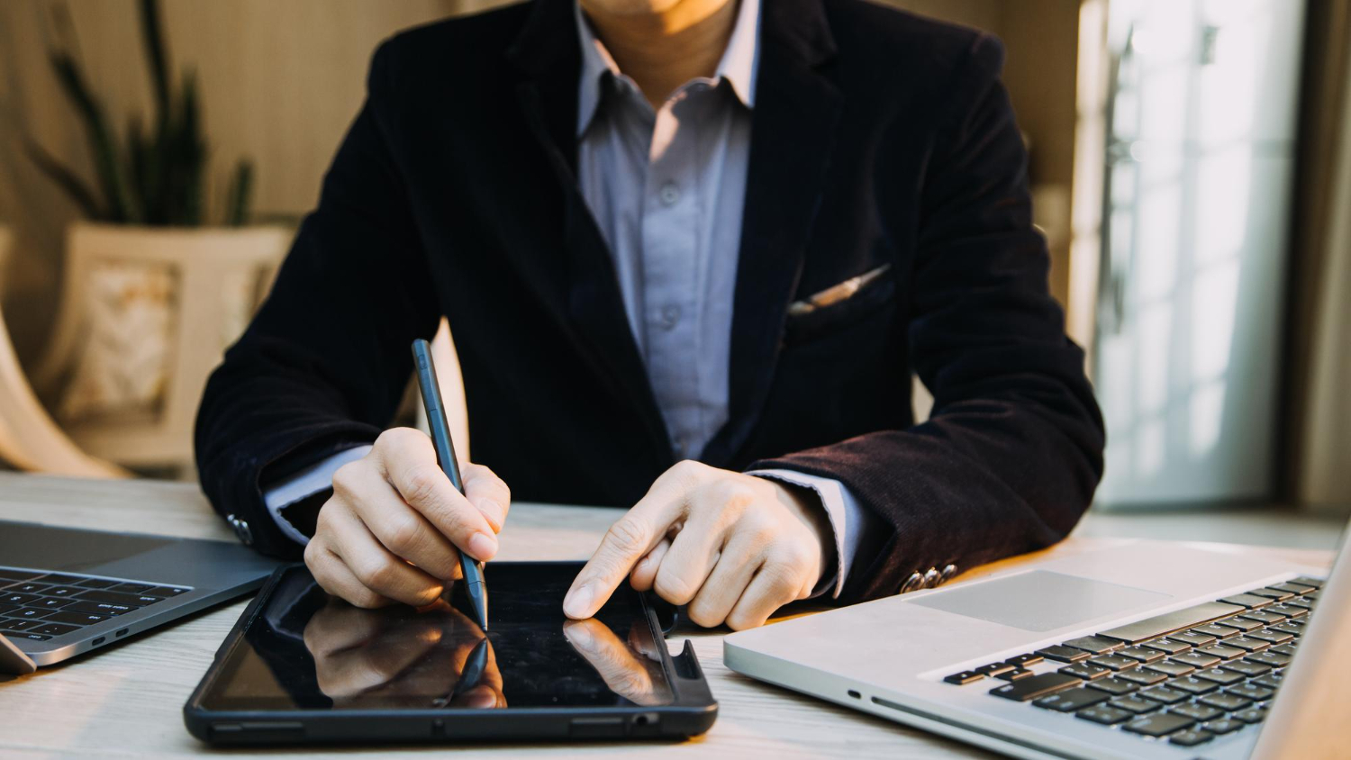 Business professional using a digital tablet to sign documents electronically, streamlining financial account opening with eSignatures.