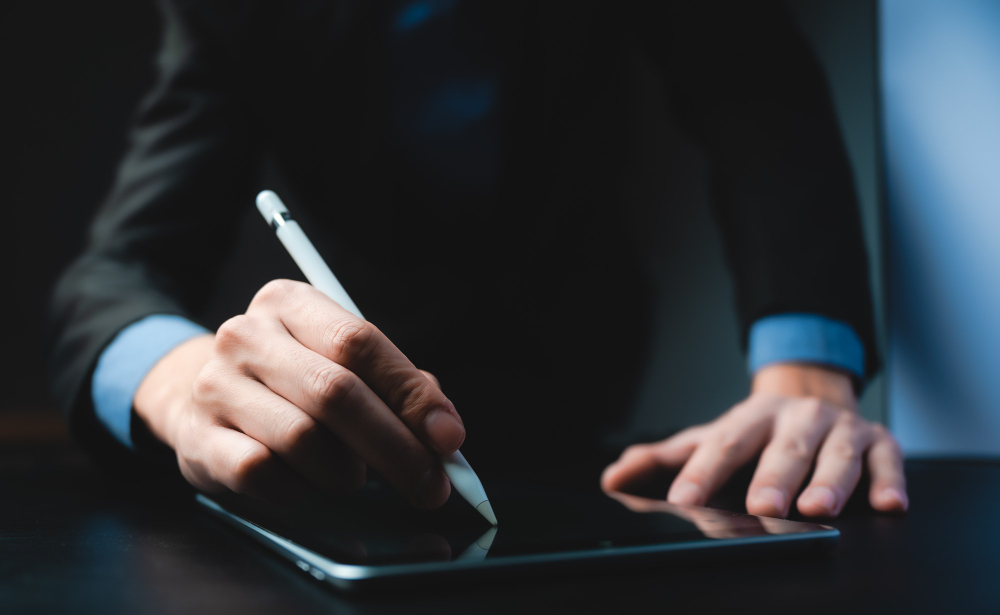 Business professional signing a digital document on a tablet using an e-signature pen — representing fast and secure online contract signing with SignBulb eSignature App.