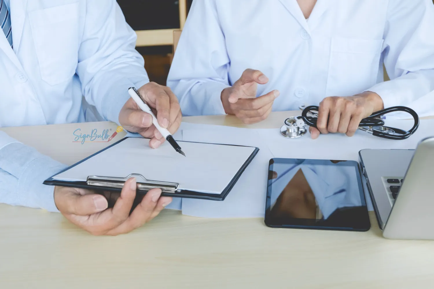 Healthcare professionals reviewing and signing documents using a digital signature app